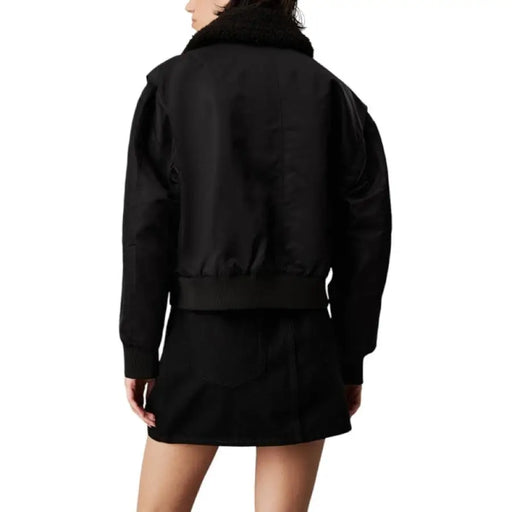 Black bomber jacket featuring a luxurious fur collar for a stylish winter look