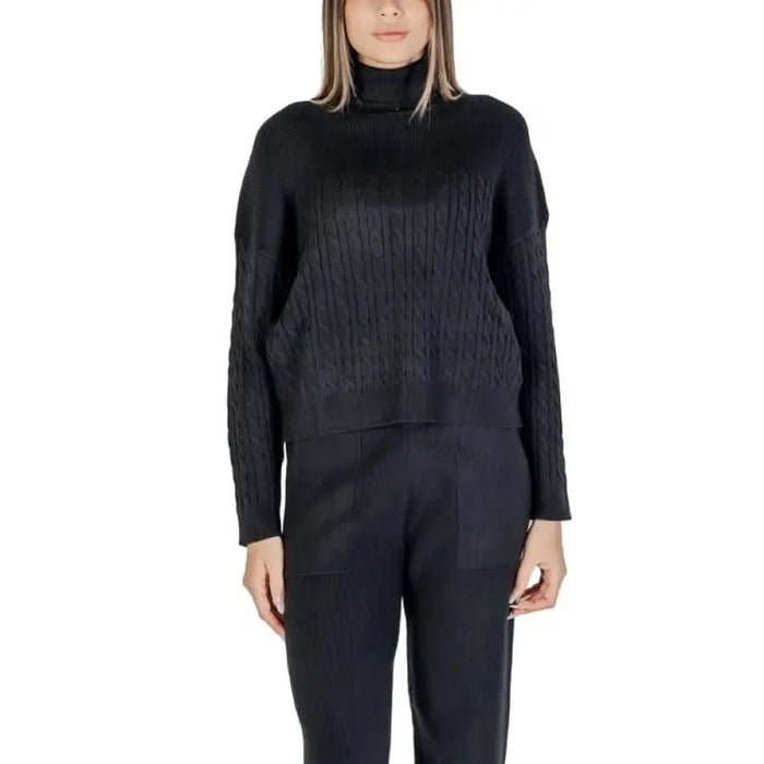 Black cable-knit turtleneck sweater and pants set from Clerè Women’s Bordeaux collection