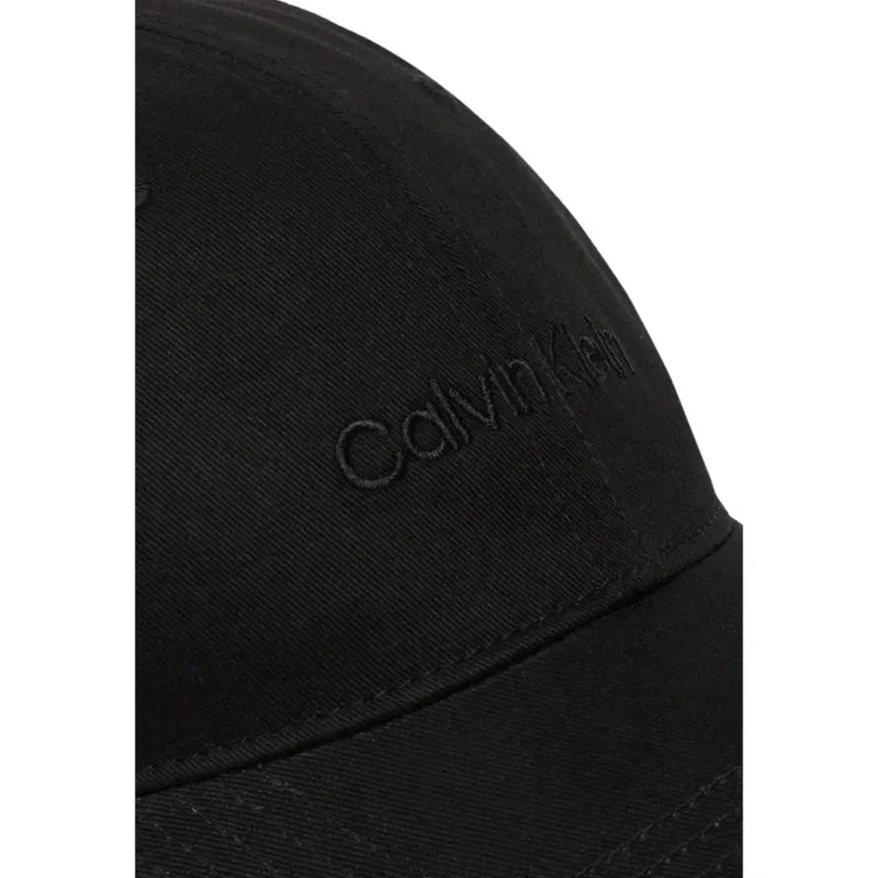Black Calvin Klein baseball cap displayed in a product image