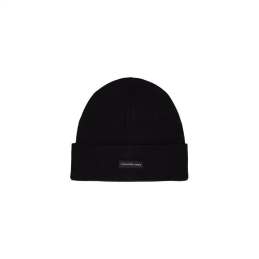 Black Calvin Klein beanie featuring gray knit fabric and logo patch detail