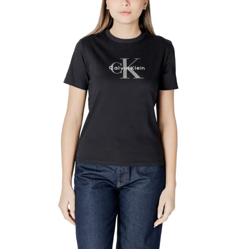 Black Calvin Klein short-sleeved round neck T shirt paired with blue jeans on female model