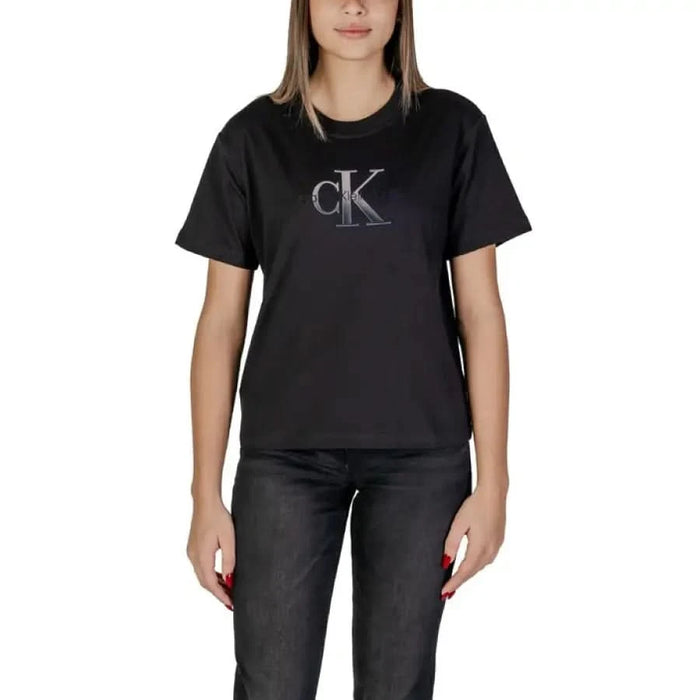 Black Calvin Klein t-shirt featuring a metallic CK logo displayed with a pink cotton top