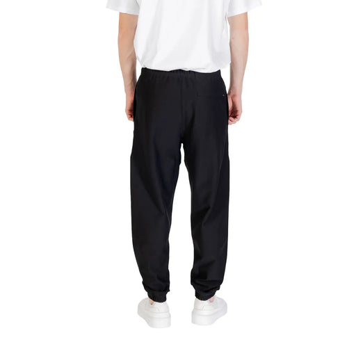 Black calvin klein sweatpants slim fit with elastic waistband drawstring and elastic cuffs in black fabric