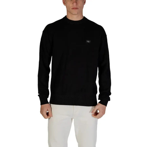 Black long-sleeved crew neck sweater displayed on a mannequin for a stylish casual look