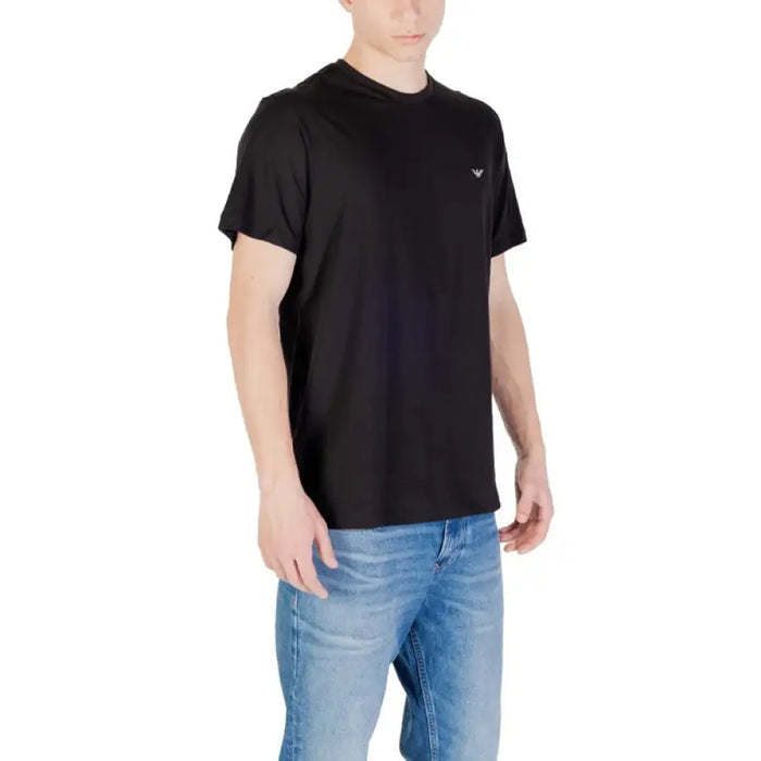 Black crew neck T-shirt displayed with blue jeans in the product image