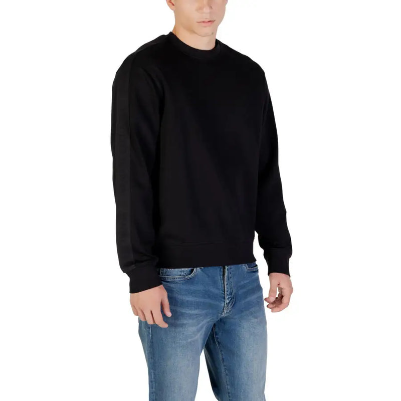 Black crewneck sweater made of soft fabric featuring long sleeves and ribbed cuffs for a comfortable fit