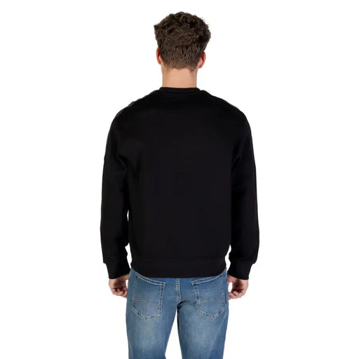 Black crewneck sweatshirt displayed in a stylish apparel product shot