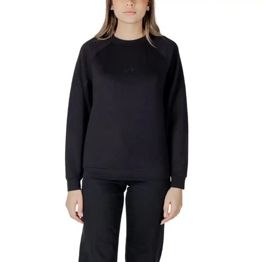 Women’s light blue sweatshirt and black pants set displayed for casual wear