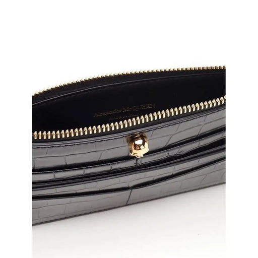 Black crocodile-patterned wallet with gold zipper and skull detail for a stylish accessory