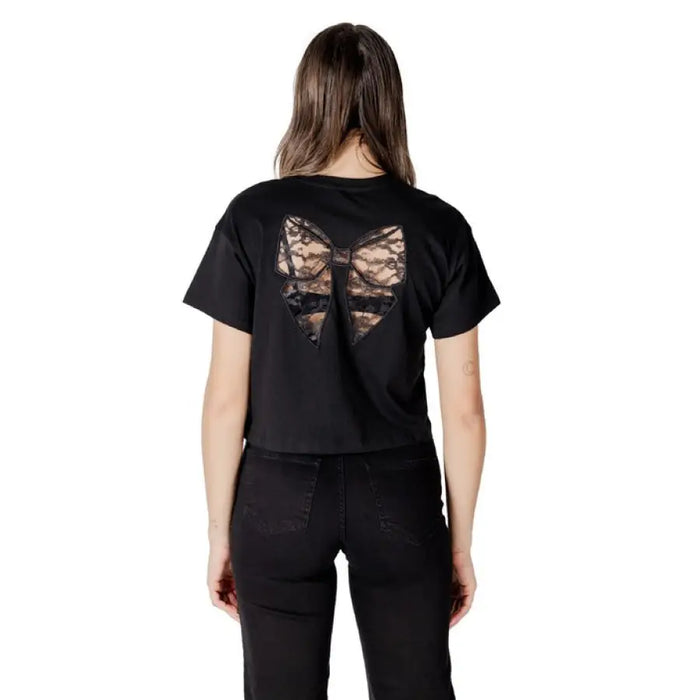 Black crop top with lace bow displayed on a mannequin in Black Cropped T Shirt and Jeans collection