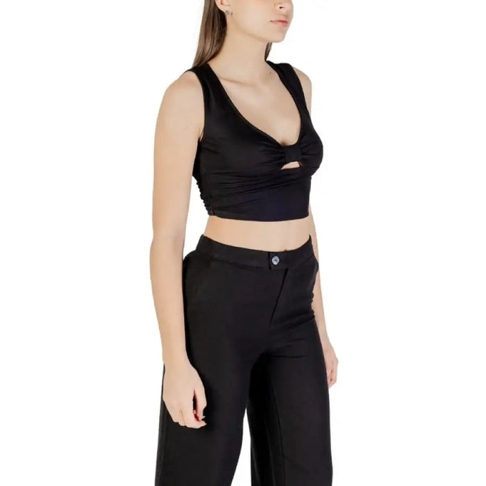 Women wearing a stylish black crop top and matching pants outfit for fashion appeal