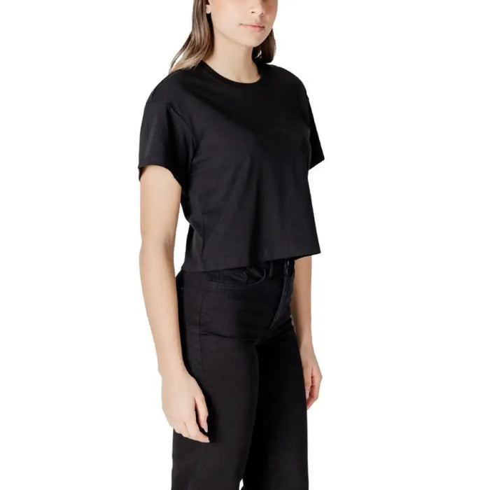 Black cropped T shirt displayed with jeans in product image