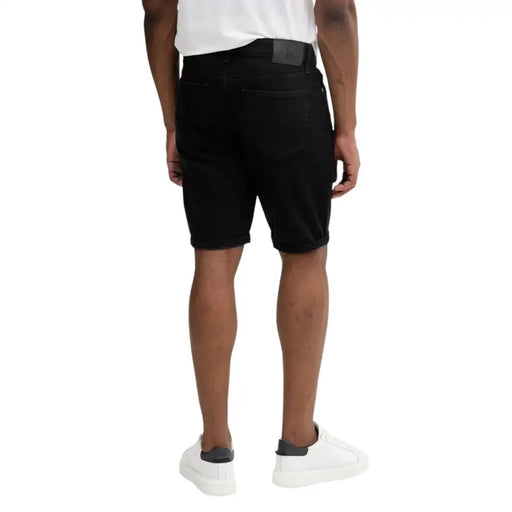 Black denim shorts displayed with a Men White T-Shirt in a fashion product image