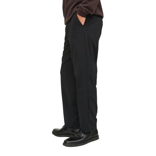 Black dress trousers featuring a buttoned back pocket for a sophisticated appearance
