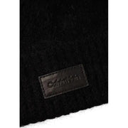 Black fuzzy scarf with leather label displayed alongside a black knit beanie