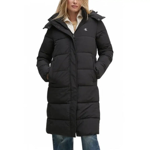 Black hooded puffer jacket with long style and quilted design for warmth and fashion