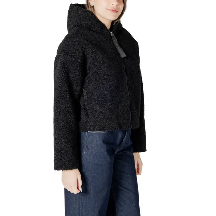 Black Hooded Sherpa Jacket displayed with plush black fleece material and a hood