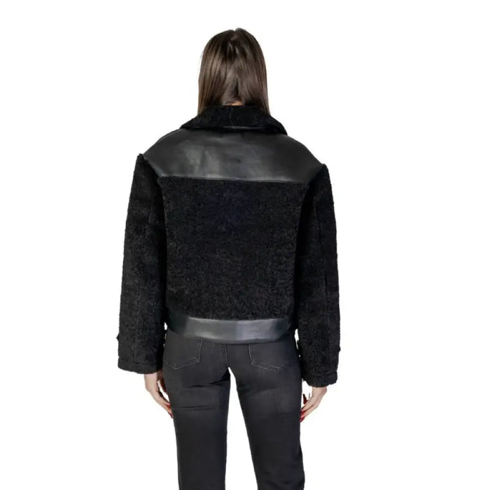 Black faux fur jacket with shearling collar and leather accents for stylish warmth