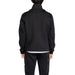 Elegant black button-up jacket and matching pants ensemble on display