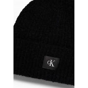 Black knit beanie with logo patch for stylish winter wear