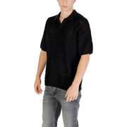 Black knit polo shirt featuring a textured openwork pattern on the chest and shoulders with short sleeves