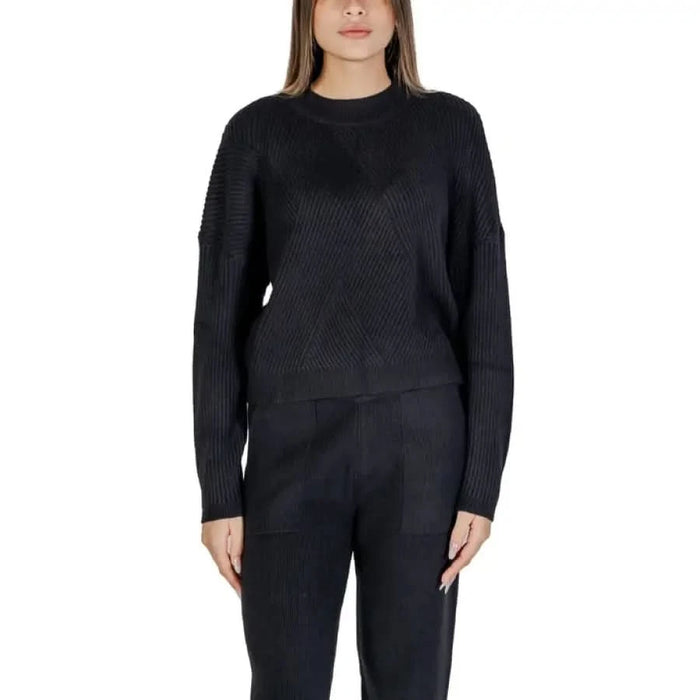Black knit sweater and pants set displayed with Purple Women’s Knitwear Sweater