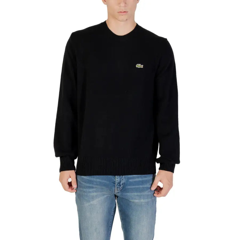 Black Lacoste Long Sleeve Sweater displayed on a mannequin in a retail store