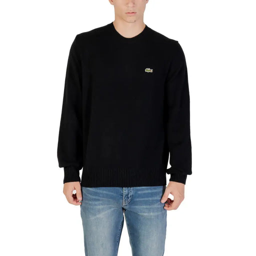 Black Lacoste Long Sleeve Sweater displayed on a mannequin in a retail store