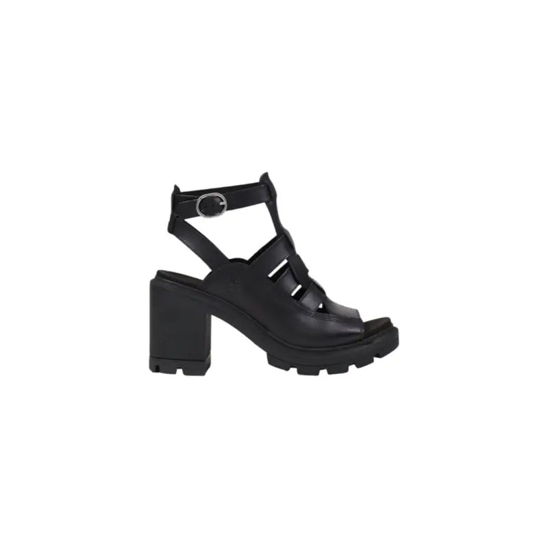 Black leather open toe heeled sandal with chunky heel and ankle strap, shown from the back side