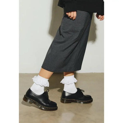 Black leather oxford shoes paired with white socks displayed in a product image