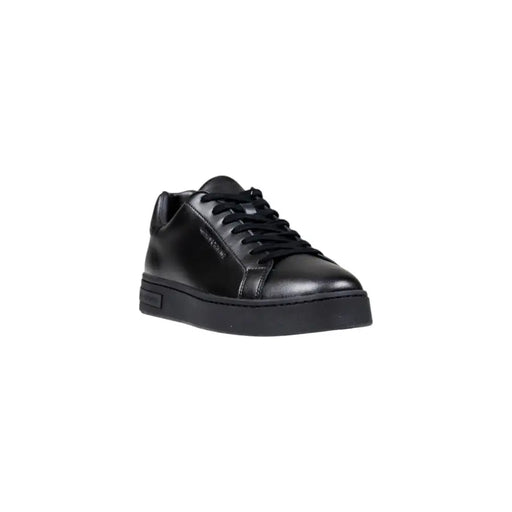 Black leather sneaker with white sole and laces, classic design.
