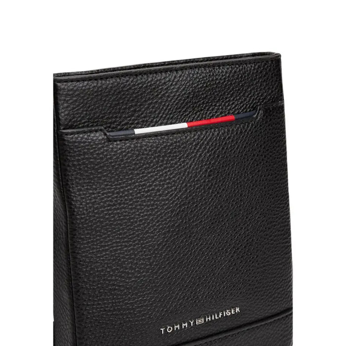 Black leather Tommy Hilfiger wallet displayed with matching crossbody bag