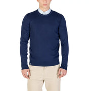 Navy blue crew neck sweater with a subtle texture and light beige pants.