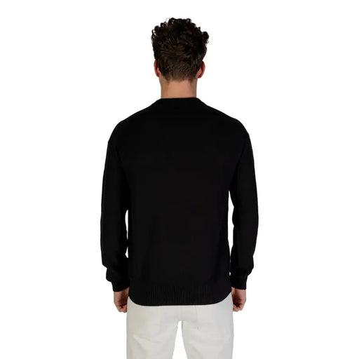 Black long-sleeved crew neck sweater displayed for men’s fashion product