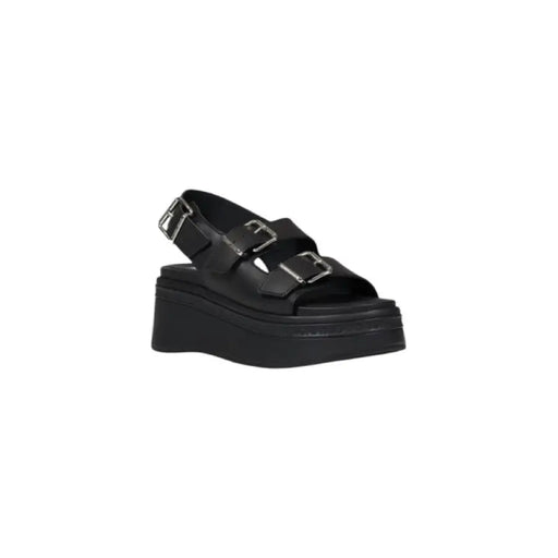 Black platform sandal with buckle straps, stylish footwear for fashion-forward individuals
