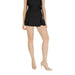 Elegant black high-waisted pleated skort paired with nude heels for sophisticated style