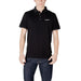 Black polo shirt paired with dark wash jeans from Armani Exchange Men’s collection