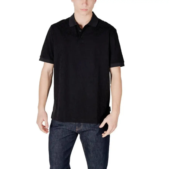 Black polo shirt paired with dark wash jeans from Armani Exchange Men’s collection