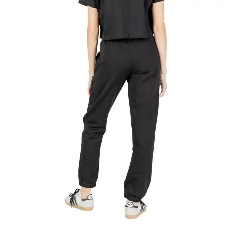 Black Adidas joggers for women with elastic cuffs, laces, and side pocket