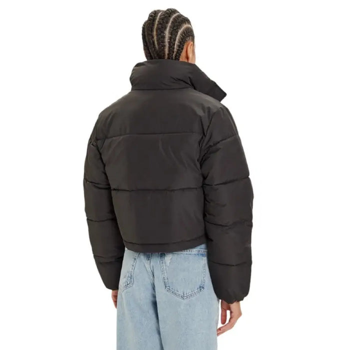 Black Calvin Klein Puffer Jacket displayed in a stylish outdoor setting