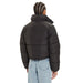 Black Calvin Klein Puffer Jacket displayed in a stylish outdoor setting