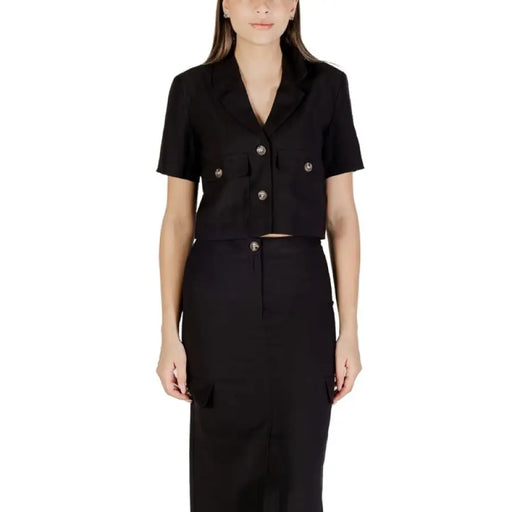 Elegant black short-sleeved blazer and skirt set displayed for stylish professional wear