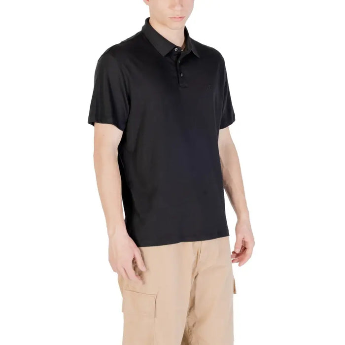 Black short-sleeved polo shirt displayed on a clothing rack for Men