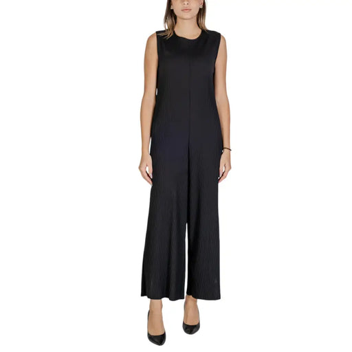Black sleeveless polyester jumpsuit with pleated bodice wide-leg pants and front zipper closure