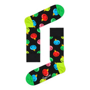 Black socks adorned with colorful smiley faces in a Gingerbread House box