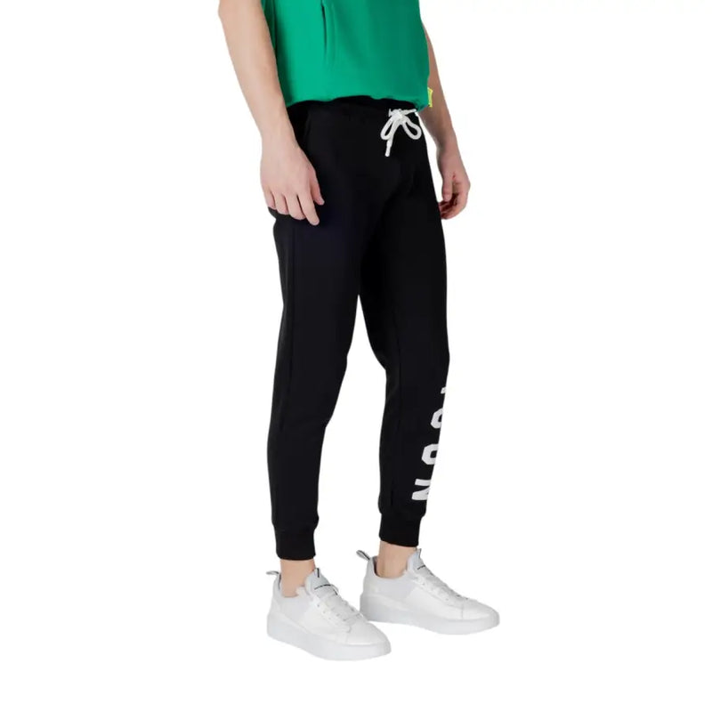 Black sweatpants with white drawstring featuring vertical lettering on the side made of comfortable jogger material