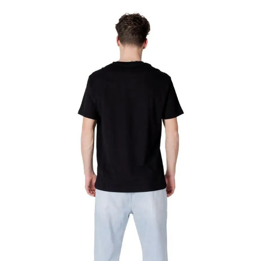 Armani Exchange Men’s Black Print Cotton T Shirt paired with light blue pants