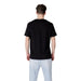 Armani Exchange Men’s Black Print Cotton T Shirt paired with light blue pants