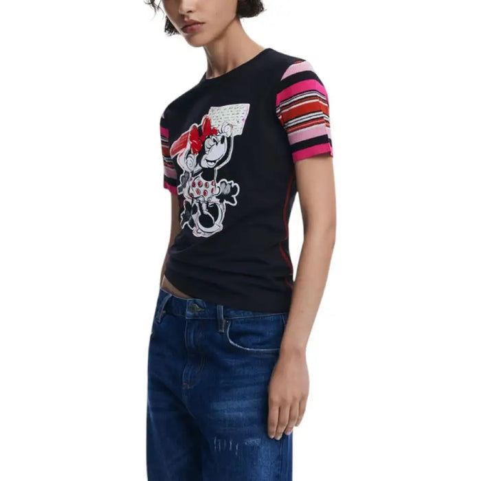 Black Minnie Mouse graphic T-shirt with striped sleeves displayed with patchwork jeans