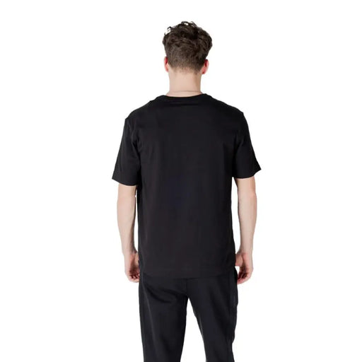 Calvin Klein black T-shirt and pants displayed together in a product image